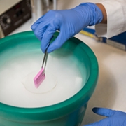researcher using ice bucket in lab