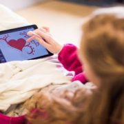 Teen Girl drawing a heart on an iPad