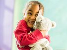 little girl holding a stuffed bear