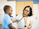 Asha Moudgil examines a young patient