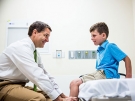 Matthew Oetgen examines a patient
