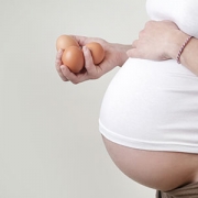 pregnant woman holding eggs