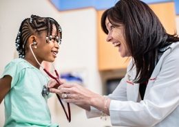 little girl being examined by doctor