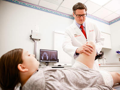 Dr. Benjamin Martin examines a patient