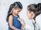 doctor giving girl checkup