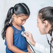 doctor giving girl checkup
