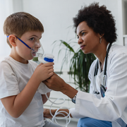 doctor helping child with asthma