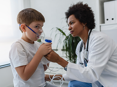 doctor helping child with asthma