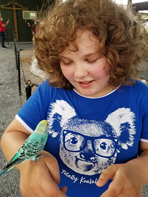 Gracie Popielarcheck with a pet bird