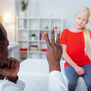 doctor showing girl with concussion three fingers