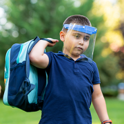 Little boy going to school with protective mask