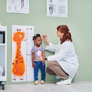 doctor measuring girl's height