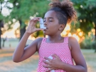 Child using inhaler for asthma