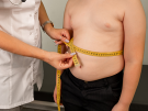 clinician measuring obese child's waist