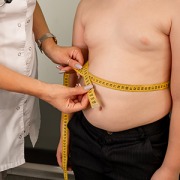 clinician measuring obese child's waist