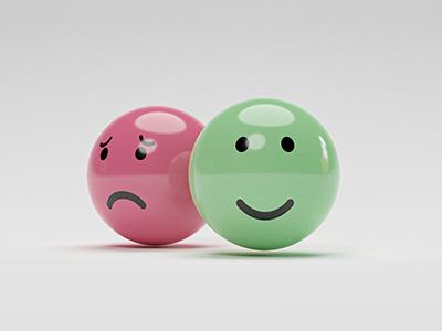 two balls -- one with a sad face and one with a happy face