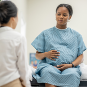 pregnant woman talking to doctor