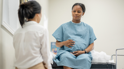pregnant woman talking to doctor
