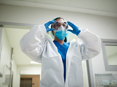 healthcare professional putting on PPE