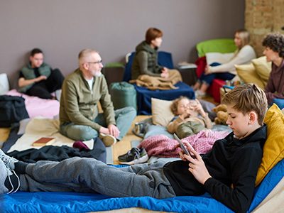 boy on cot in emergency shelter