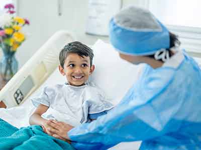 Smiling boy in hospital bed