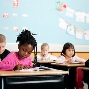 Kids sitting at desks in school