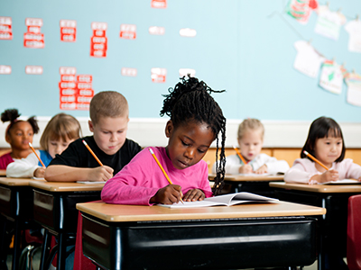 Kids sitting at desks in school