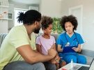 A father and daughter talk to a doctor