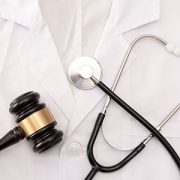 Stethoscope and gavel on a labcoat