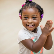 Young girl smiling and clapping