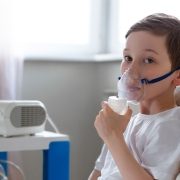 Boy in bed with oxygen mask