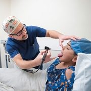 Diego Preciado, MD, PhD, examines a patient
