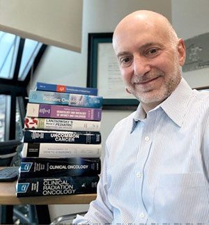 Dr. Jeffrey Dome poses with books he authored