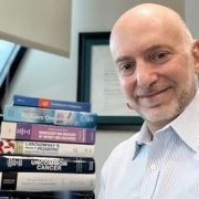 Dr. Jeffrey Dome poses with books he authored