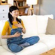 woman meditating on a couch