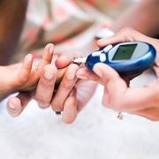 Mother checking child's blood glucose levels