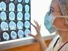 doctor looking at brain scan images