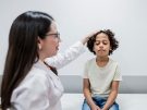 boy with concussion being examined by a doctor