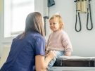 doctor examines toddler