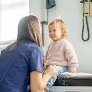 doctor examines toddler
