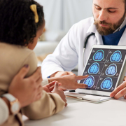 doctor showing brain scans to mom and daughter