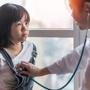 doctor listening to girl's heart