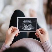 pregnant woman holding sonogram