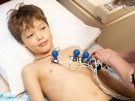 boy undergoing electrocardiogram test in clinic