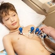 boy undergoing electrocardiogram test in clinic
