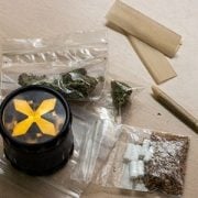 Marijuana buds, grinder, joint, rolling papers for smoking