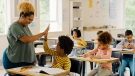 boy giving his teacher a high five