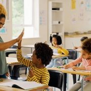 boy giving his teacher a high five